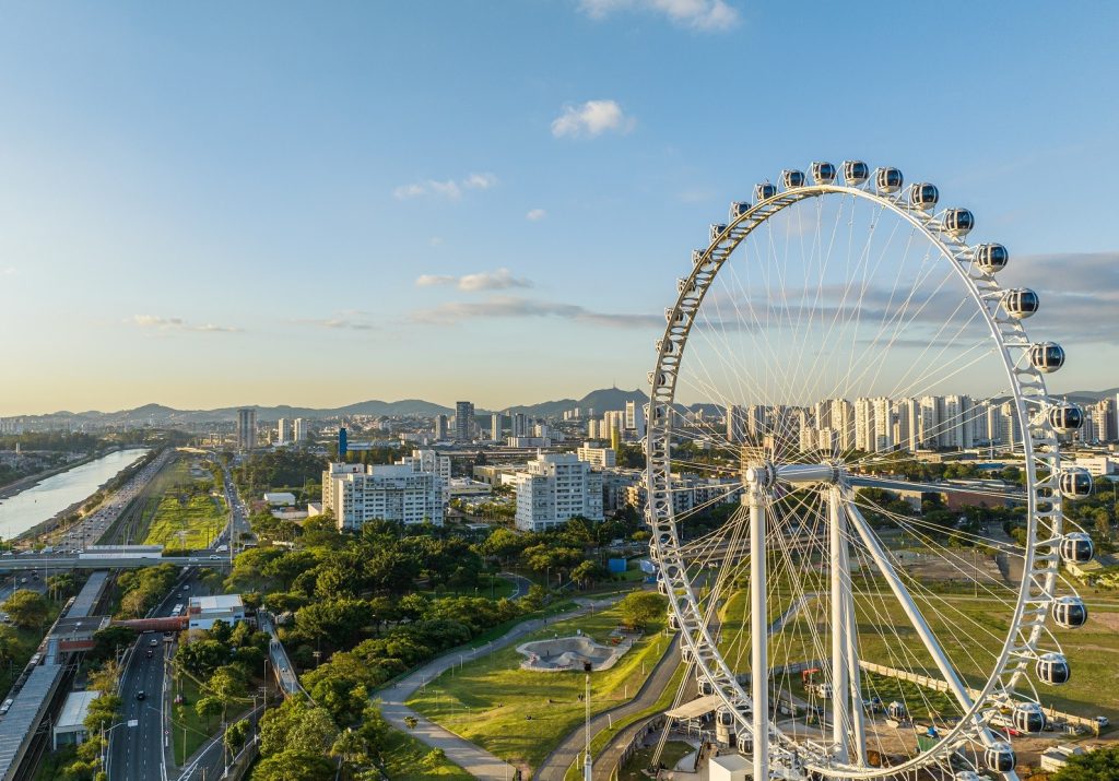 imagem mostra roda gigante durante o dia, céu ensolarado